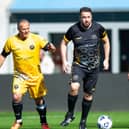 Jason Manford and Adam Thomas playing for the celebrities team with Clayton Blackmore from the legends side. Photo: Manchester Remembers