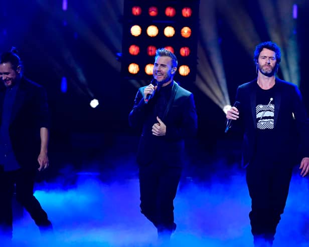 Take That bandmates Mark Owen, Gary Barlow and Howard Donald