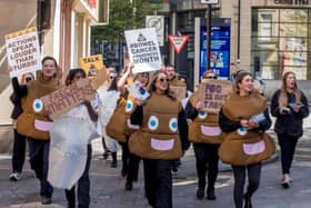 Campaigners dressed  as poos and loo rolls walking through Manchester to raise awareness of bowel cancer. Photo: Chris Payne