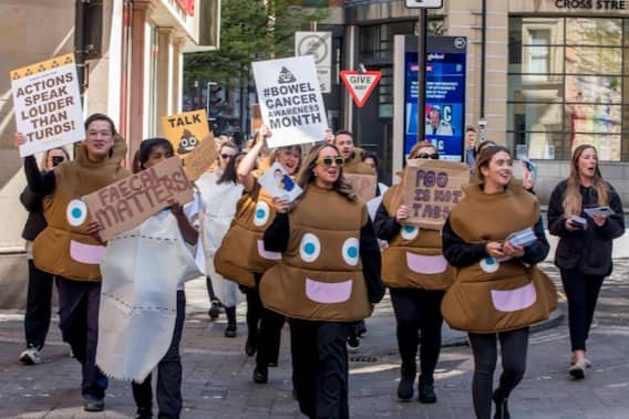 Campaigners dressed  as poos and loo rolls walking through Manchester to raise awareness of bowel cancer. Photo: Chris Payne