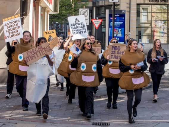 Campaigners dressed  as poos and loo rolls walking through Manchester to raise awareness of bowel cancer. Photo: Chris Payne