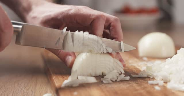 Putting a wet paper towel next to the chopping board supposedly helps stop your eyes from watering (Photo: Adobe)