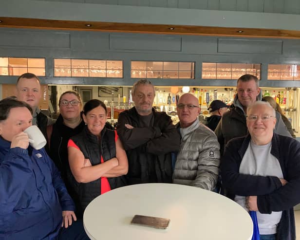 Regulars of the Queens pub in Monsall who gathered to show support for their favourite boozers Credit: LDRS