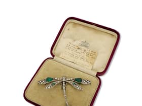 This emerald and diamond dragonfly brooch worn at three royal coronations has gone up for sale at Mayfair’s oldest family jewellers for £350,000.