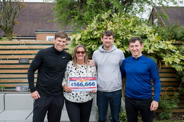 Garry’s garden memorial - Lesley and her three sons, Alan (left), Steven and Matthew (right) beside their beloved husband and dad’s remembrance plaque