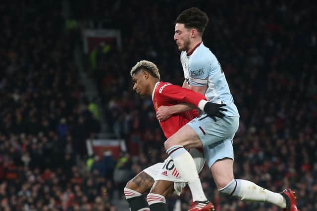 Marcus Rashford of Manchester United with Declan Rice of West Ham during the Premier League match between Manchester United and West Ham at Old Trafford on January 22, 2022. (Photo by Matthew Peters/Manchester United via Getty Images)