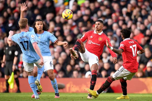 Nathan Ake of Manchester City and Marcus Rashford of Manchester United battle for the ball