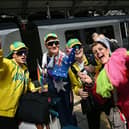 Eurovision super-fans arrive at Lime Street Station in Liverpool. Photo by Paul ELLIS / AFP) (Photo by PAUL ELLIS/AFP via Getty Images)