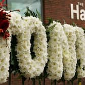 A floral tribute to Factory Records founder Tony Wilson outside the apartments where the iconic Hacienda once stood. Photo: Getty Images