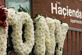 A floral tribute to Factory Records founder Tony Wilson outside the apartments where the iconic Hacienda once stood. Photo: Getty Images