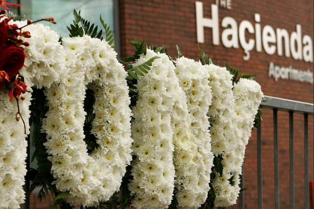 A floral tribute to Factory Records founder Tony Wilson outside the apartments where the iconic Hacienda once stood. Photo: Getty Images