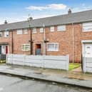 The property is a terraced home and features a small front garden