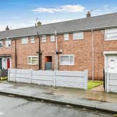 The property is a terraced home and features a small front garden