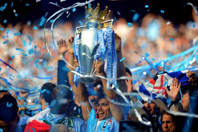 Scorer of the matchwinning goal Sergio Aguero of Manchester City celebrates with the trophy . (Photo by Shaun Botterill/Getty Images)