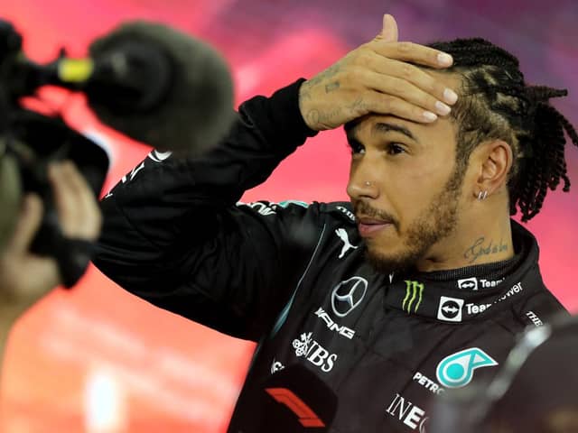 Second-placed Mercedes' British driver Lewis Hamilton reacts in the parc ferme of the Yas Marina Circuit after the Abu Dhabi Formula One Grand Prix on December 12, 2021 (Getty Images)
