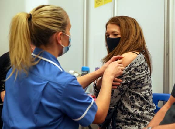 Caroline Nicolls receives an injection of the Moderna Covid-19 vaccine administered by nurse Amy Nash, at the Madejski Stadium, Reading (Getty Images)
