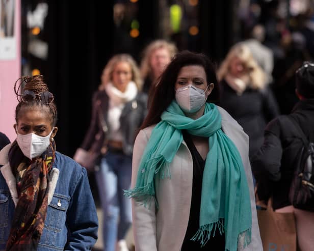 A woman wears a face mask while walking on Oxford Street durng the height of the coronavirus pandemic.