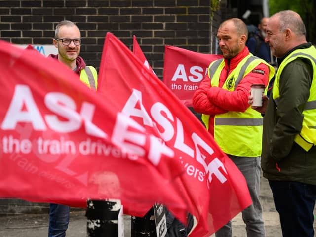 LONDON, ENGLAND - MAY 31: A group of rail workers stand on a picket line outside Euston rail station as a new round of strikes by train drivers begins on May 31, 2023 in London, England. Today's strike comes after the train drivers union, ASLEF, rejected a pay rise offer of 4 percent a year over two years from the Rail Delivery Group (RDG). (Photo by Leon Neal/Getty Images)