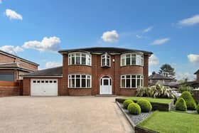 The front of the home has a large driveway with plenty of space for multiple cars