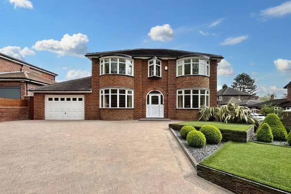 The front of the home has a large driveway with plenty of space for multiple cars