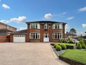 The front of the home has a large driveway with plenty of space for multiple cars