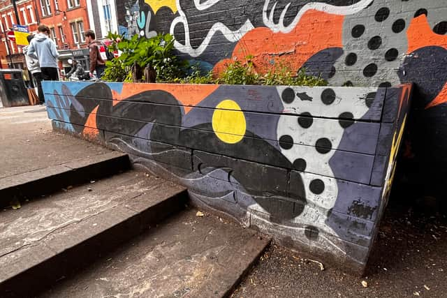 You can just make out the wave patterns and reference to the River Tib at the bottom of this planter near the Tib Street car park. 