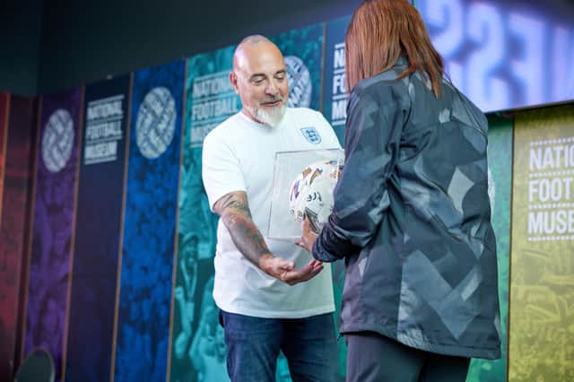 Keith Batt, son of manager Harry, receives the specially-commissioned ball