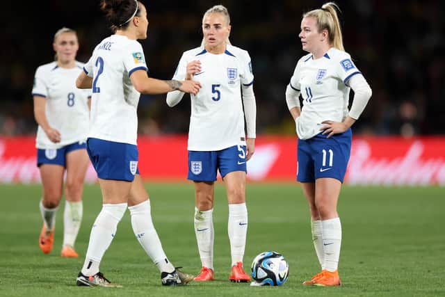 Lucy Bronze, Alex Greenwood and Lauren Hemp of England discuss tactics during the FIFA Women's World Cup Australia & New Zealand 2023 Quarter Final match between England and Colombia at Stadium Australia on August 12, 2023 in Sydney, Australia. (Photo by Catherine Ivill/Getty Images )