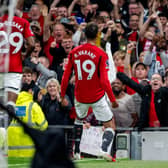 Raphael Varane of Manchester United celebrates in front of fans