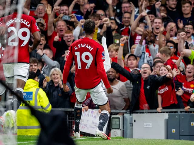 Raphael Varane of Manchester United celebrates in front of fans