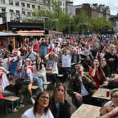Fans have their heads in their hands in Piccadilly Gardens