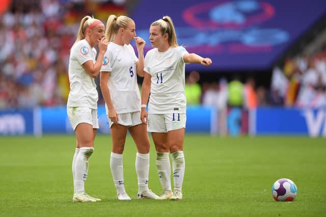Chloe Kelly speaks with Alex Greenwood and Lauren Hemp of England before taking a free kick during the UEFA Women's Euro 2022 final match between England and Germany at Wembley Stadium on July 31, 2022 in London, England. (Photo by Harriet Lander/Getty Images)