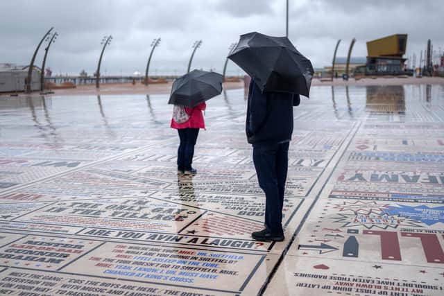 Holidaymakers brave the rain on Blackpool promenade on August 14.