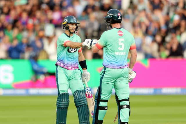 Tom Curran bumps gloves with James Neesham of Oval Invincibles during The Hundred Final between Oval Invincibles Men and Manchester Originals Men at Lord's Cricket Ground on August 27, 2023 in London, England. (Photo by Julian Finney/Getty Images)