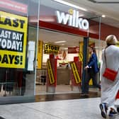  Shoppers walk past a Wilko store in Putney on September 12.