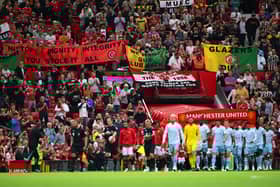 Man Utd fans raise banners in protest of the Glazers.