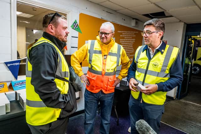 Andy Burnham (R), Mayor of Greater Manchester, meets Go-Ahead drivers involved in operating the city's first Bee Network buses, along with Nigel Featham, Managing Director of Go North West (centre).