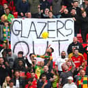 Man Utd fans hold up a ‘Glazers out’ sign at Old Trafford 
