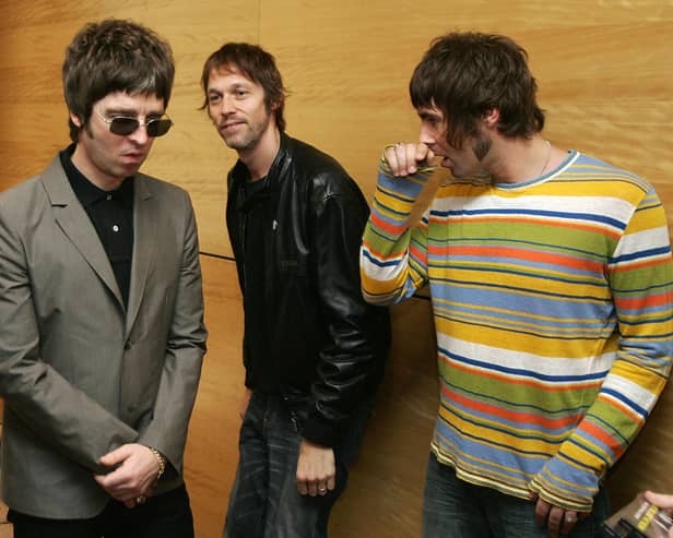 Noel Gallagher (L) Andy Bell (C) Liam Gallagher, members of the British rock band "Oasis" hold a photocall in Hong Kong 25 February 2006.