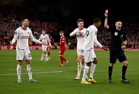 Diogo Dalot can't hide his bemusement after being sent off by Michael Oliver at Anfield 