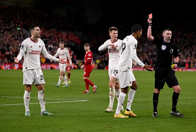 Diogo Dalot can't hide his bemusement after being sent off by Michael Oliver at Anfield 