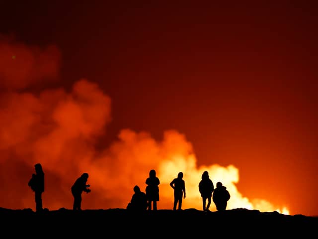 People view the volcano on the Reykjanes peninsula in south west Iceland which has erupted after weeks of intense earthquake activity/ on December 19, 2023 in Grindavik, Icelan