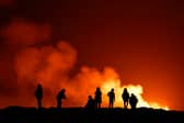 People view the volcano on the Reykjanes peninsula in south west Iceland which has erupted after weeks of intense earthquake activity/ on December 19, 2023 in Grindavik, Icelan