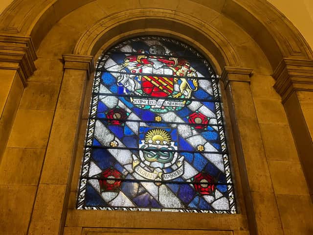 A stained glass window inside Manchester's Central Library showing Manchester's heraldry.