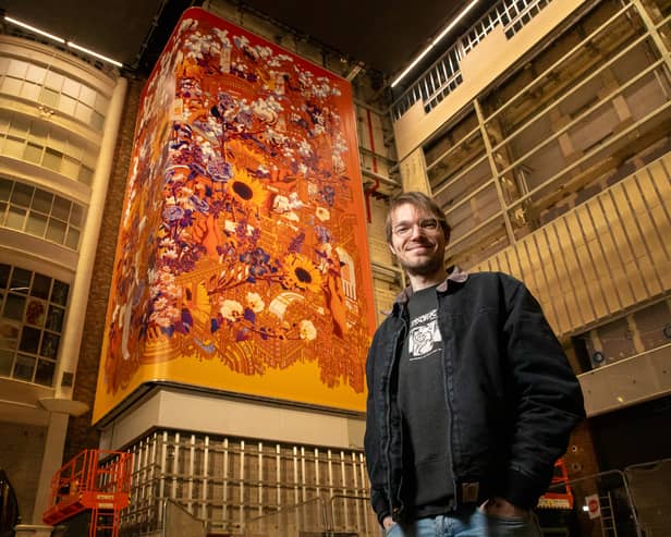 Alex Sylt, artist, pictured with his work at the Printworks.. Picture Jason Lock Photography