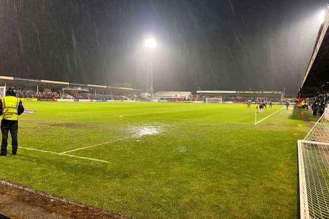 The waterlogged pitch at Cambridge as the rain came down. 