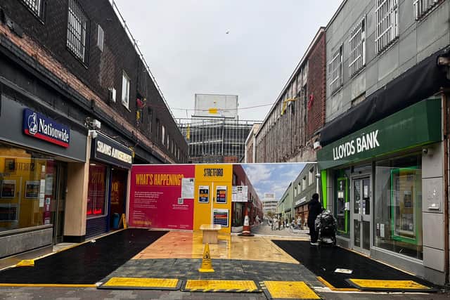 Stretford's King Street and a poster of the upcoming redevelopment of the area.