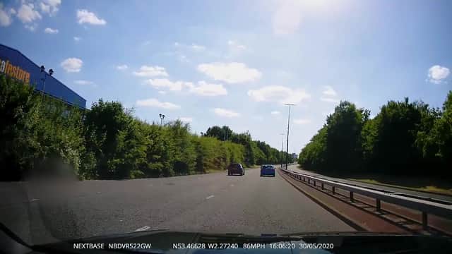A still from the dashcam footage which captures the moment three joyriders raced their own Audis though Manchester.