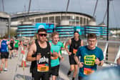 Runners pass The Etihad Stadium