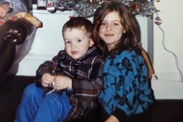 My cousin visiting us at the house in Preston Street at Christmas - he's well wrapped up. I'm the girl in the blue jumper